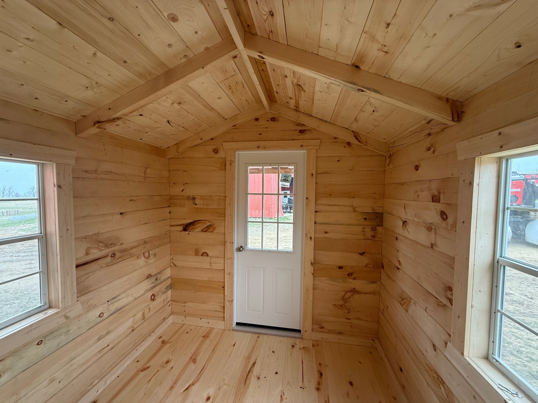 Cabin interior looking toward the front door with side windows