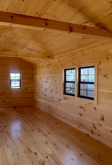 Pine cabin interior with vaulted ceiling and beams